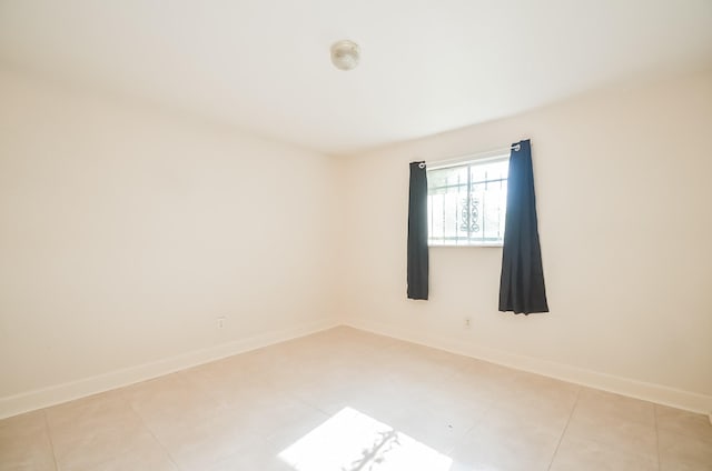 12806 Bauman Rd, North Houston, TX 77037 - empty room with baseboards and light tile patterned floors