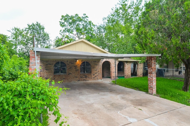 12806 Bauman Rd, North Houston, TX 77037 - view of front of home featuring concrete driveway, board and batten siding, and brick siding