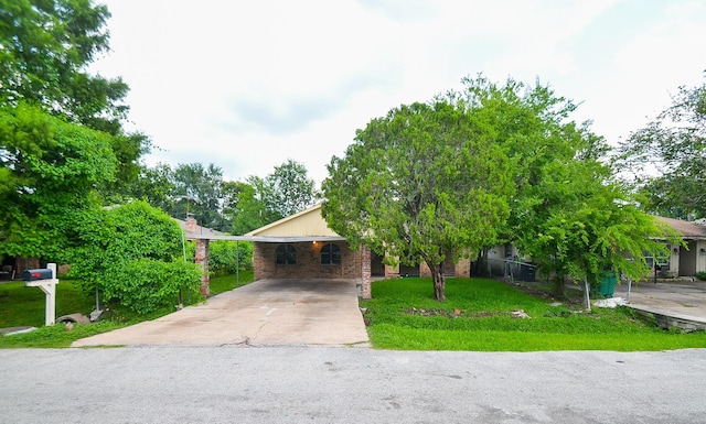 12806 Bauman Rd, North Houston, TX 77037 - obstructed view of property featuring concrete driveway and brick siding