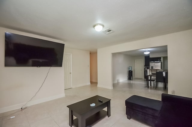 12806 Bauman Rd, North Houston, TX 77037 - living area with light tile patterned floors and baseboards