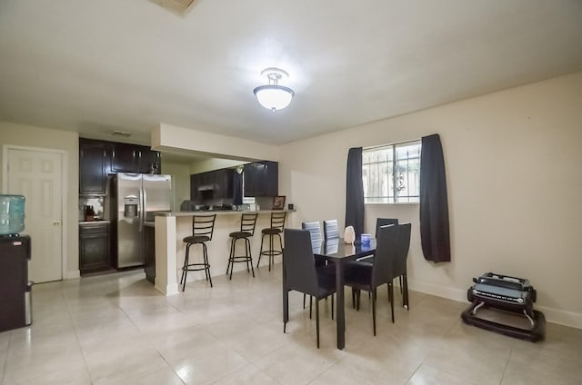 12806 Bauman Rd, North Houston, TX 77037 - dining room featuring light tile patterned floors and baseboards