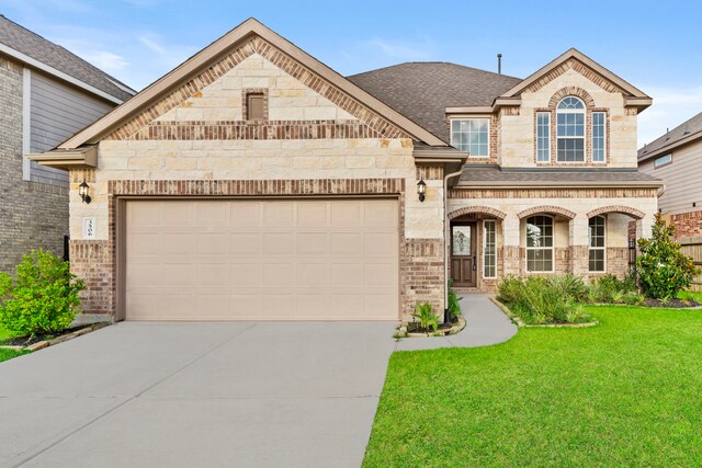 3506 Lake Bella Megan Dr, Katy, TX 77493 - french country inspired facade featuring concrete driveway, a front yard, brick siding, and an attached garage