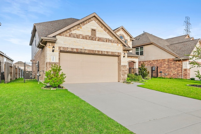 3506 Lake Bella Megan Dr, Katy, TX 77493 - french provincial home featuring a garage, driveway, brick siding, stone siding, and a gate