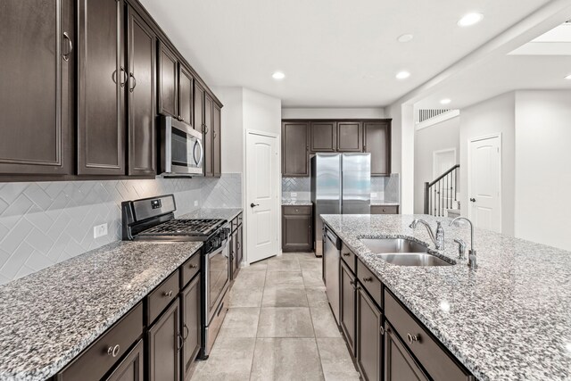 3506 Lake Bella Megan Dr, Katy, TX 77493 - kitchen with stainless steel appliances, backsplash, dark brown cabinets, light stone counters, and recessed lighting