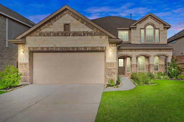 3506 Lake Bella Megan Dr, Katy, TX 77493 - french provincial home featuring concrete driveway, a front yard, an attached garage, and brick siding