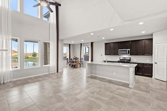 3506 Lake Bella Megan Dr, Katy, TX 77493 - kitchen featuring appliances with stainless steel finishes, a towering ceiling, plenty of natural light, recessed lighting, and ceiling fan
