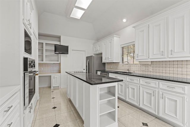 1015 Flagmore Dr, Katy, TX 77450 - kitchen with open shelves, appliances with stainless steel finishes, light tile patterned flooring, tasteful backsplash, and lofted ceiling