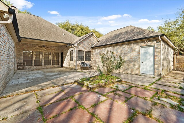 1015 Flagmore Dr, Katy, TX 77450 - back of property with a patio area, a ceiling fan, a shingled roof, brick siding, and a chimney