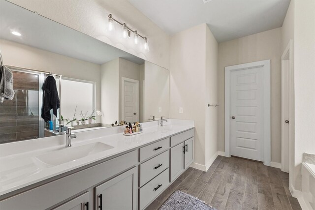2231 Bright Sunrise Trl, Fresno, TX 77545 - full bath featuring double vanity, wood finished floors, and a tile shower