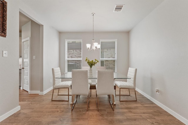 2231 Bright Sunrise Trl, Fresno, TX 77545 - dining room with wood finished floors and a chandelier