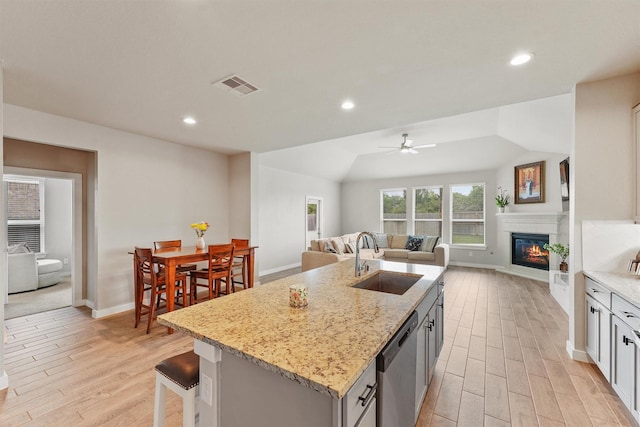 2231 Bright Sunrise Trl, Fresno, TX 77545 - kitchen with stainless steel dishwasher, open floor plan, light wood finished floors, and recessed lighting