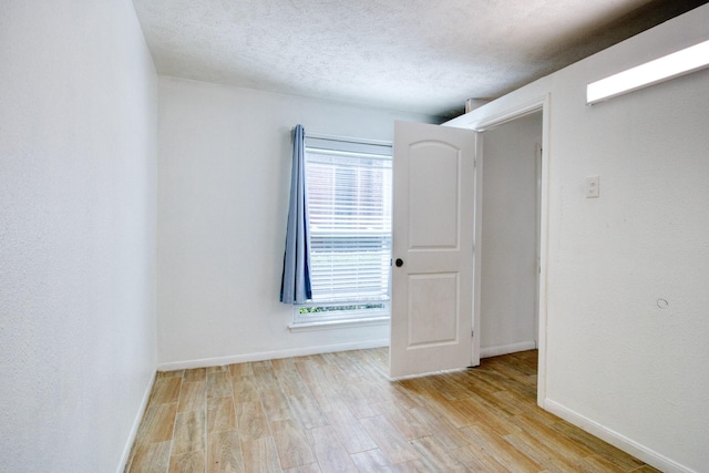 11667 Sabo Rd, Houston, TX 77089 - empty room featuring light wood-style flooring, plenty of natural light, and a textured ceiling