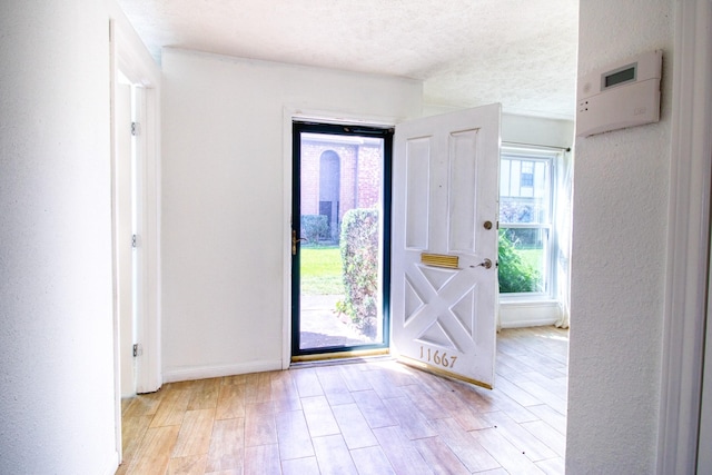 11667 Sabo Rd, Houston, TX 77089 - entryway featuring light wood-style flooring and a textured ceiling
