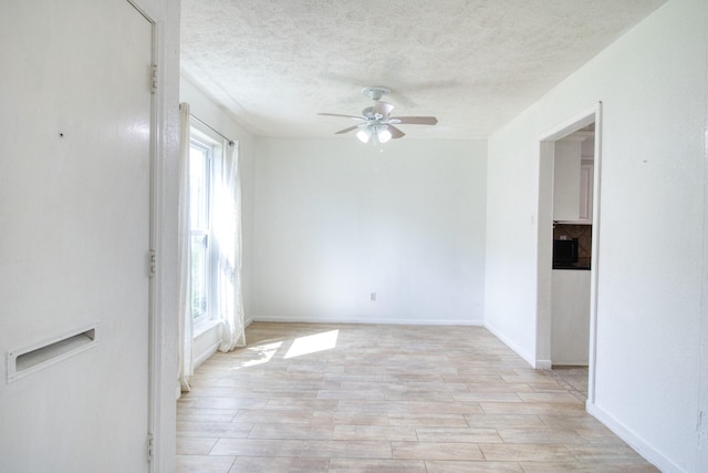 11667 Sabo Rd, Houston, TX 77089 - unfurnished room with ceiling fan, a textured ceiling, and light wood-style floors