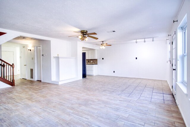 11667 Sabo Rd, Houston, TX 77089 - unfurnished living room featuring a ceiling fan, light wood-style flooring, and stairs