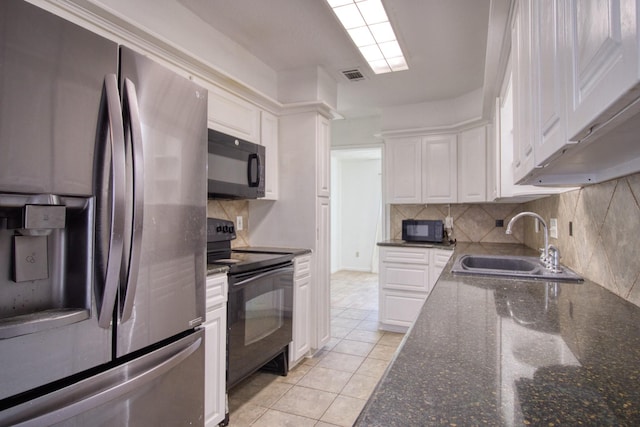 11667 Sabo Rd, Houston, TX 77089 - kitchen featuring black appliances, white cabinetry, and tasteful backsplash