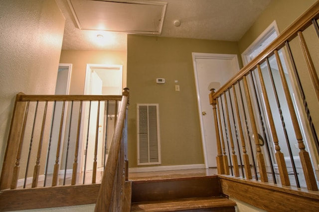 11667 Sabo Rd, Houston, TX 77089 - stairway with attic access and a textured wall