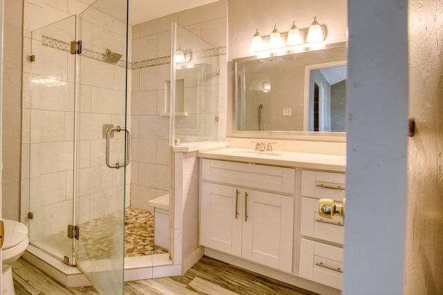 11667 Sabo Rd, Houston, TX 77089 - bathroom with a shower stall, vanity, and wood finished floors