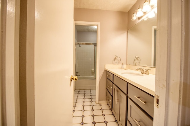 11667 Sabo Rd, Houston, TX 77089 - full bathroom with vanity, shower / bath combination with glass door, tile patterned floors, and a textured ceiling