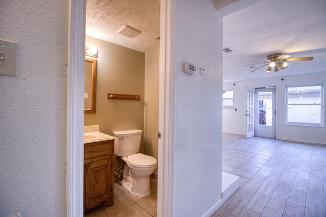 11667 Sabo Rd, Houston, TX 77089 - bathroom with a textured wall, vanity, a textured ceiling, and a ceiling fan
