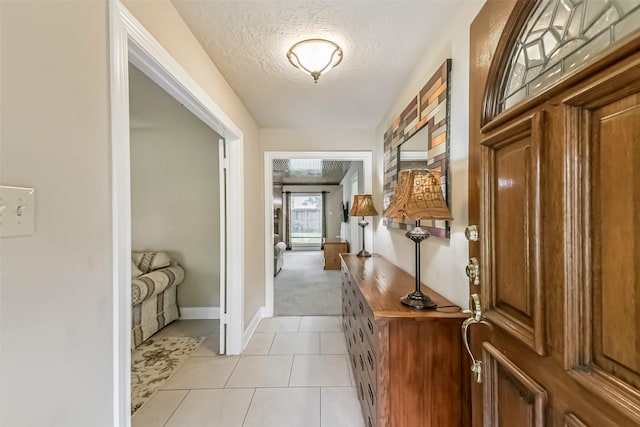 3914 Cherry Forest Dr, Houston, TX 77088 - foyer with a textured ceiling, light colored carpet, and light tile patterned floors