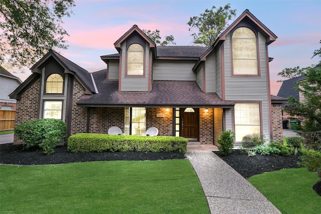 3914 Cherry Forest Dr, Houston, TX 77088 - view of front of house with brick siding, a front lawn, and a shingled roof