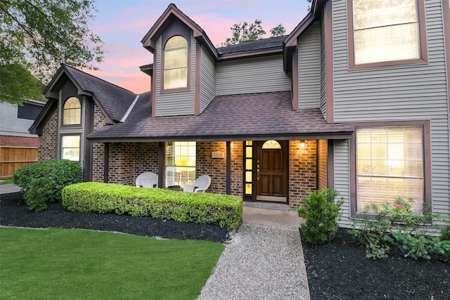 3914 Cherry Forest Dr, Houston, TX 77088 - view of front of property featuring brick siding, a porch, a front lawn, and roof with shingles