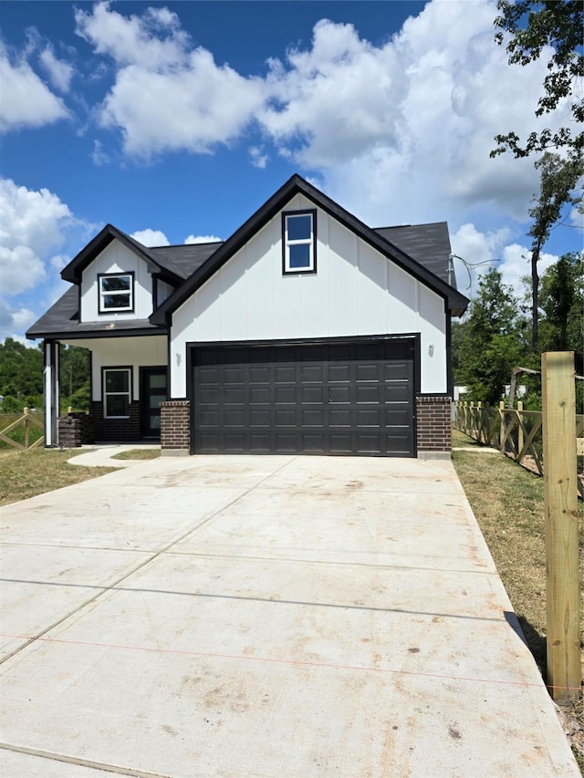 14387 Half Circle St, Splendora, TX 77372 - view of front of property with brick siding, a garage, and driveway