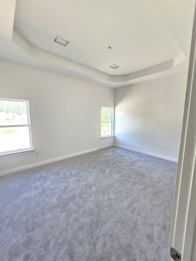 14387 Half Circle St, Splendora, TX 77372 - carpeted spare room featuring a tray ceiling and baseboards