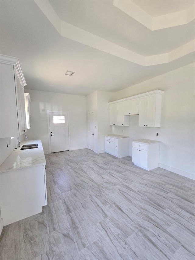 14387 Half Circle St, Splendora, TX 77372 - kitchen featuring white cabinets, light stone countertops, and a tray ceiling