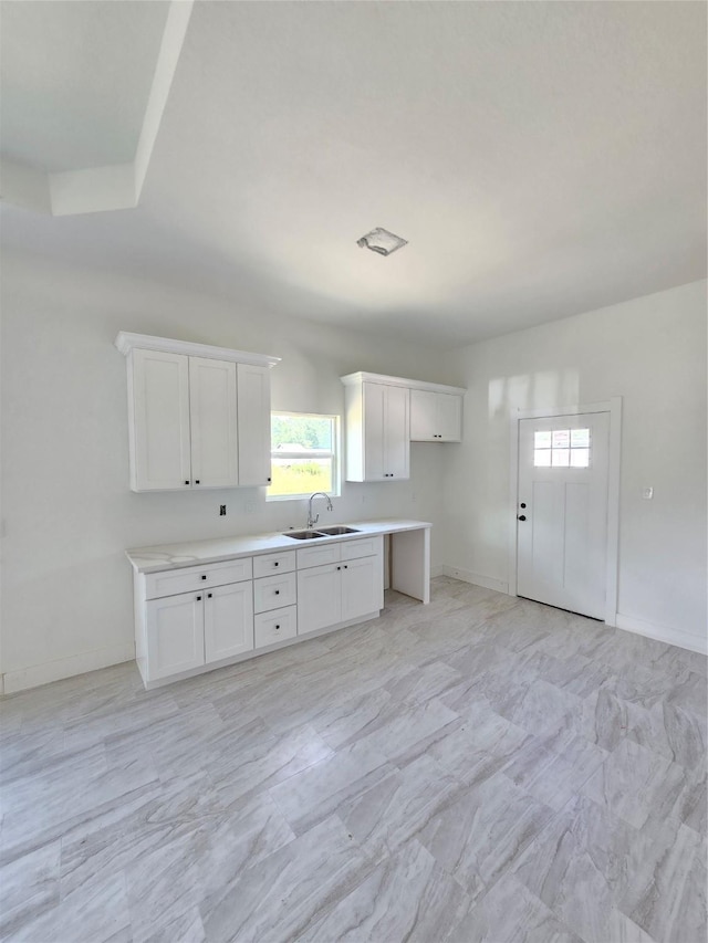 14387 Half Circle St, Splendora, TX 77372 - kitchen featuring white cabinets and light countertops