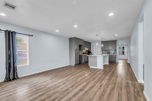 8215 Canyon St, Houston, TX 77051 - unfurnished living room with wood finished floors, healthy amount of natural light, and recessed lighting