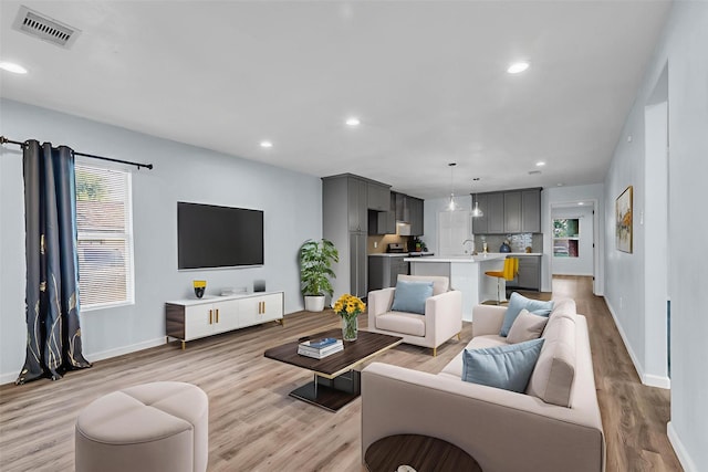 8215 Canyon St, Houston, TX 77051 - living room featuring light wood-type flooring and recessed lighting