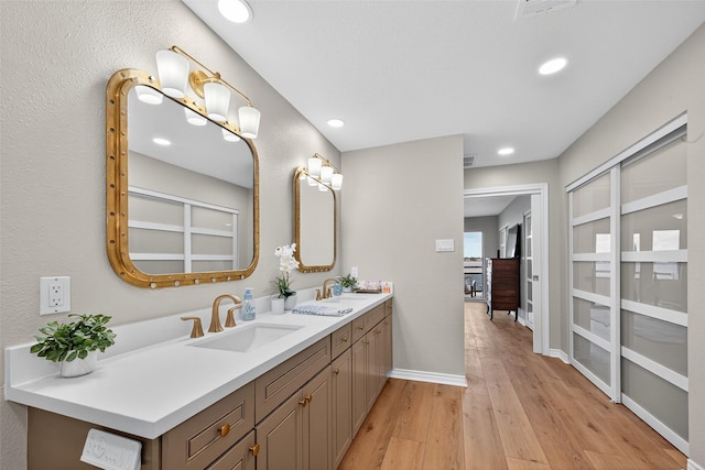 3663 Nasa Pkwy Unit 301, Seabrook, TX 77586 - full bathroom with double vanity, wood finished floors, and recessed lighting
