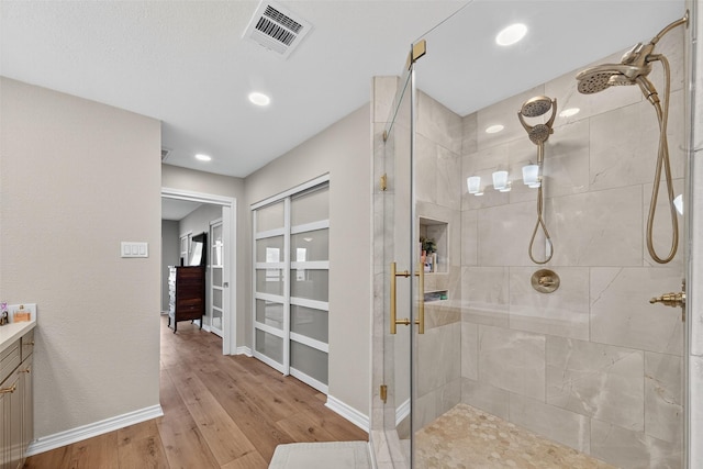 3663 Nasa Pkwy Unit 301, Seabrook, TX 77586 - full bath with a stall shower, vanity, wood finished floors, and recessed lighting