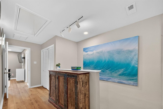3663 Nasa Pkwy Unit 301, Seabrook, TX 77586 - hallway with attic access, track lighting, light wood finished floors, and recessed lighting