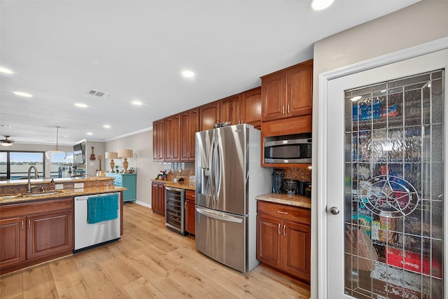 3663 Nasa Pkwy Unit 301, Seabrook, TX 77586 - kitchen with stainless steel appliances, beverage cooler, light wood finished floors, recessed lighting, and crown molding