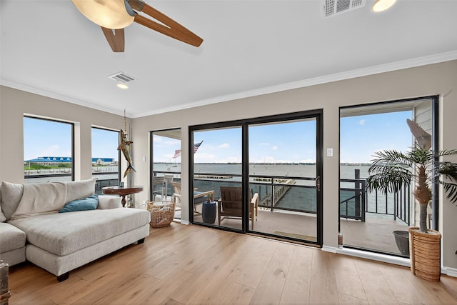 3663 Nasa Pkwy Unit 301, Seabrook, TX 77586 - living area featuring ceiling fan, wood finished floors, ornamental molding, a water view, and recessed lighting