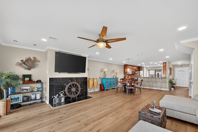 3663 Nasa Pkwy Unit 301, Seabrook, TX 77586 - living room featuring recessed lighting, ornamental molding, a fireplace, a ceiling fan, and wood finished floors