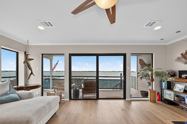 3663 Nasa Pkwy Unit 301, Seabrook, TX 77586 - living room featuring healthy amount of natural light, ornamental molding, ceiling fan, a water view, and wood finished floors