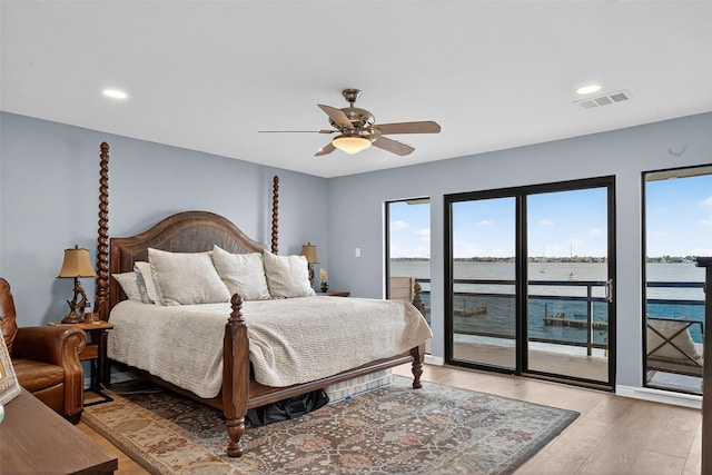 3663 Nasa Pkwy Unit 301, Seabrook, TX 77586 - bedroom featuring access to exterior, light wood-style floors, a water view, recessed lighting, and ceiling fan