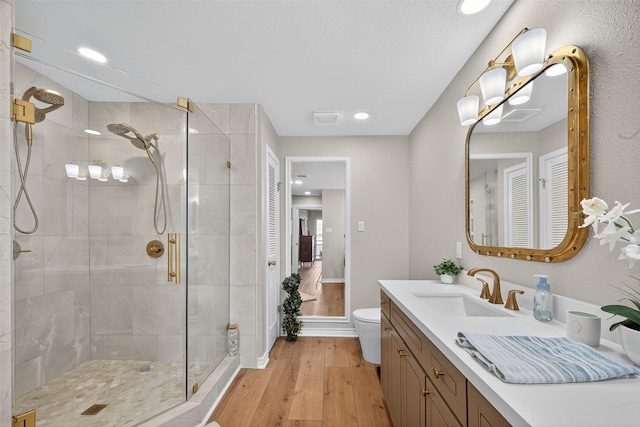 3663 Nasa Pkwy Unit 301, Seabrook, TX 77586 - full bathroom featuring wood finished floors, a shower stall, vanity, and recessed lighting