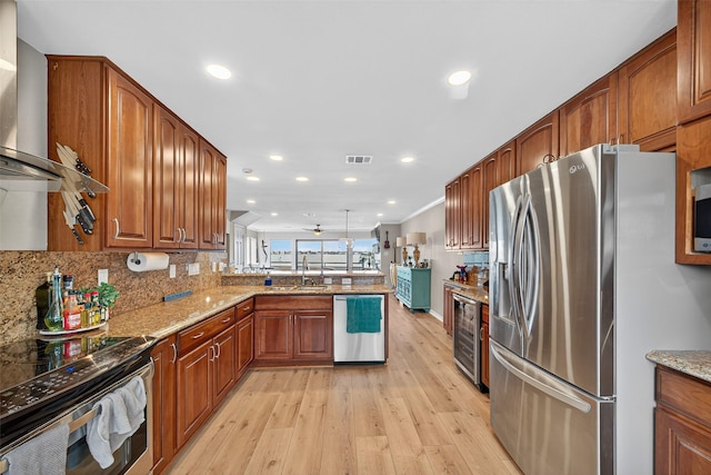 3663 Nasa Pkwy Unit 301, Seabrook, TX 77586 - kitchen featuring stainless steel appliances, light wood-type flooring, a peninsula, beverage cooler, and recessed lighting