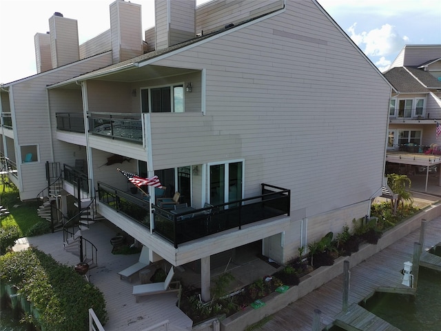 3663 Nasa Pkwy Unit 301, Seabrook, TX 77586 - rear view of house with a chimney and a balcony