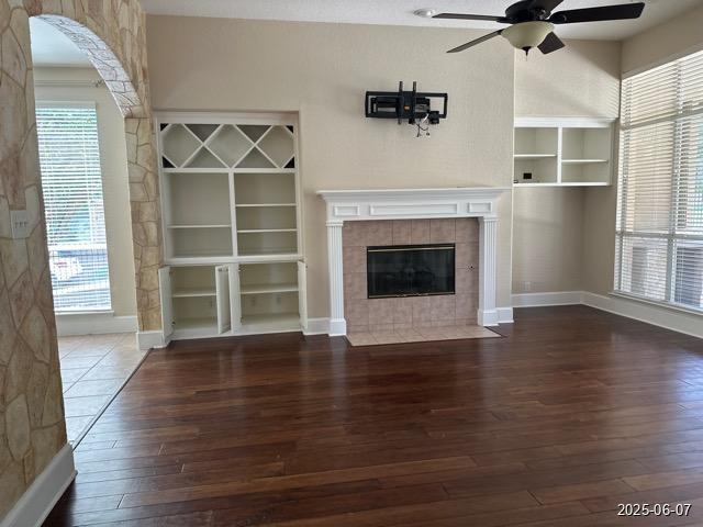 1715 Palmer Vw, San Antonio, TX 78260 - unfurnished living room with hardwood / wood-style flooring, a ceiling fan, and a tiled fireplace