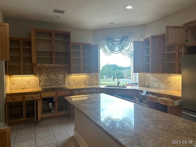 1715 Palmer Vw, San Antonio, TX 78260 - kitchen featuring open shelves, freestanding refrigerator, decorative backsplash, black electric cooktop, and light tile patterned flooring