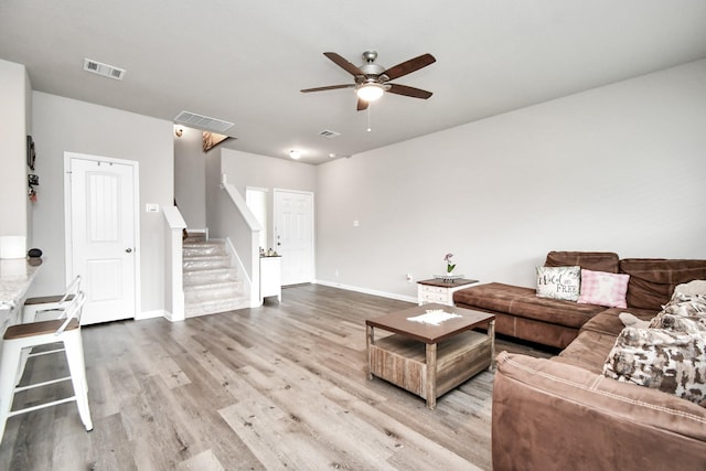 2832 Madison Dr, Conroe, TX 77304 - living area featuring stairway, a ceiling fan, and wood finished floors