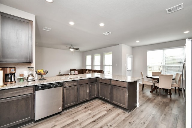 2832 Madison Dr, Conroe, TX 77304 - kitchen with stainless steel appliances, plenty of natural light, dark brown cabinetry, light wood-style floors, and recessed lighting