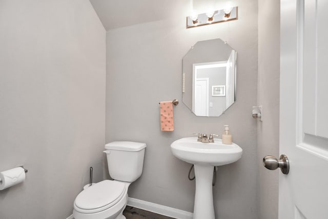 2832 Madison Dr, Conroe, TX 77304 - half bathroom featuring toilet and baseboards