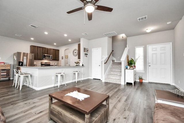 2832 Madison Dr, Conroe, TX 77304 - living room featuring wood finished floors, stairway, a ceiling fan, and recessed lighting